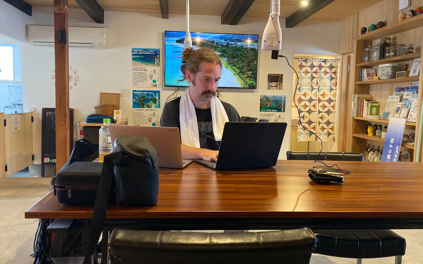 Founder working at a laptop in a warm advisory workspace in Japan