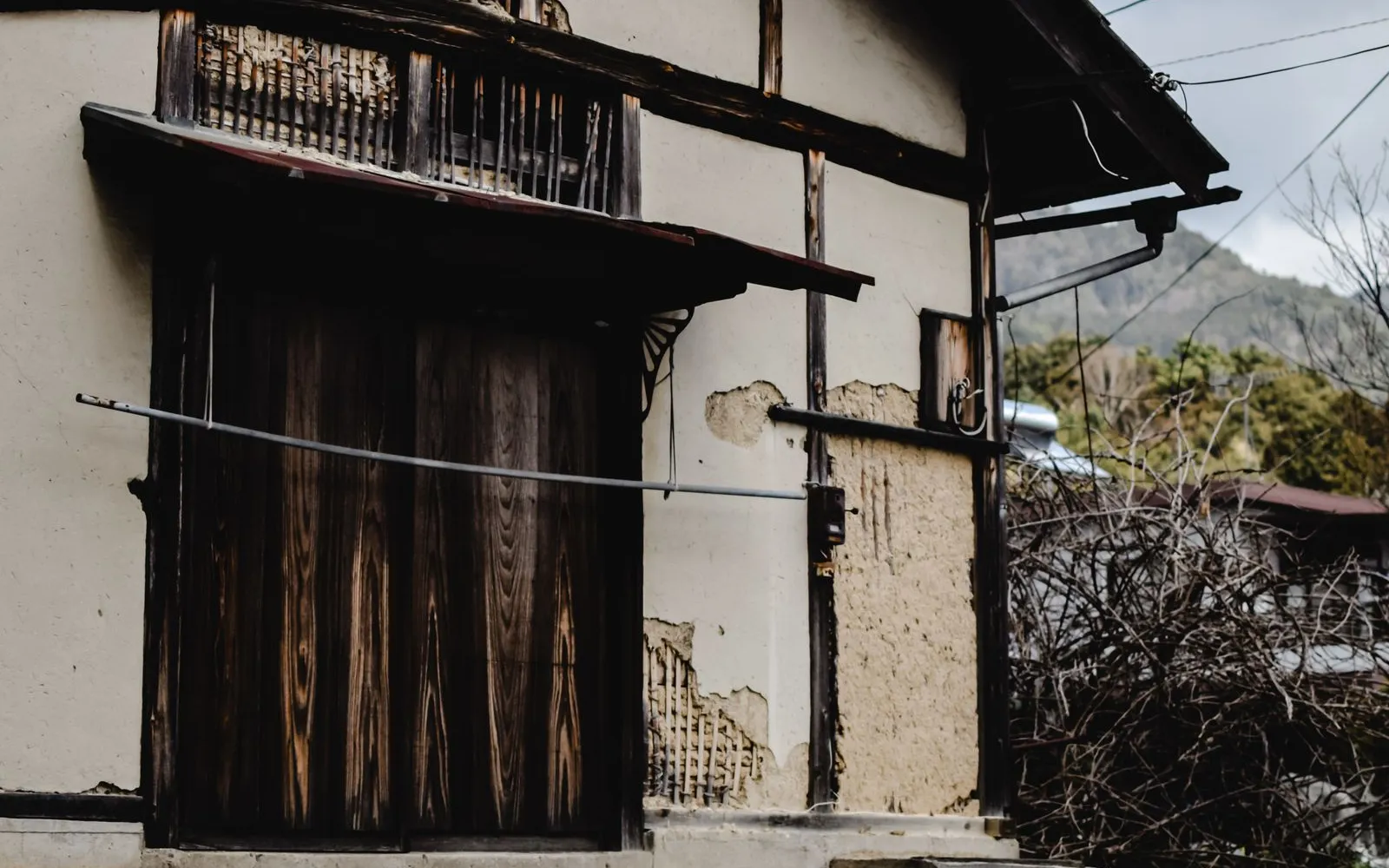 An old storehouse in Wazuka, Kyoto, where fallen plaster exposes the bamboo lattice inside its earthen wall