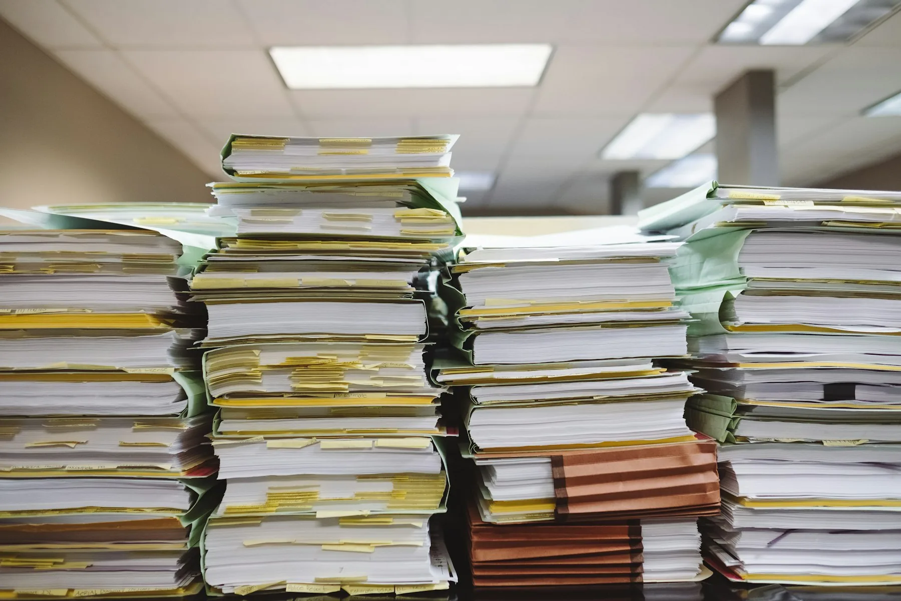 Stacks of paper documents and file folders