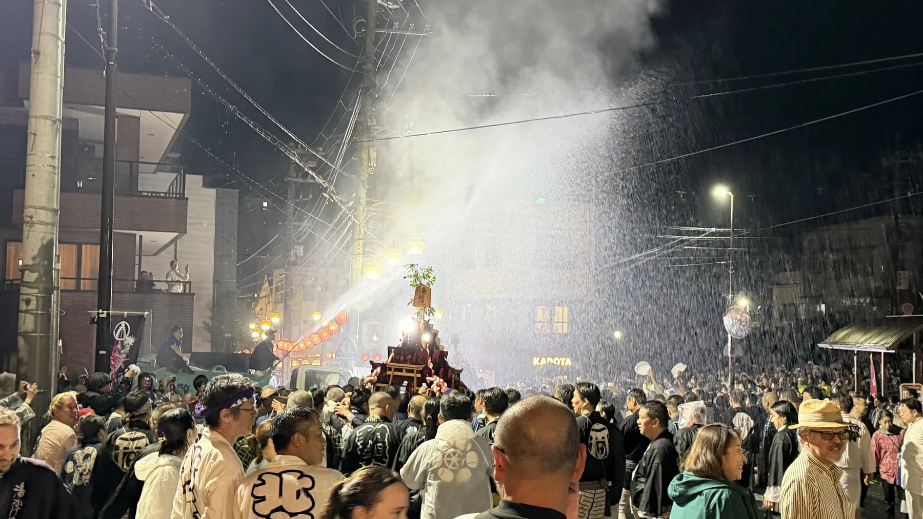 A night scene in Japan with smoke, sparks, and people gathered outdoors, used as a metaphor for local cultural discovery