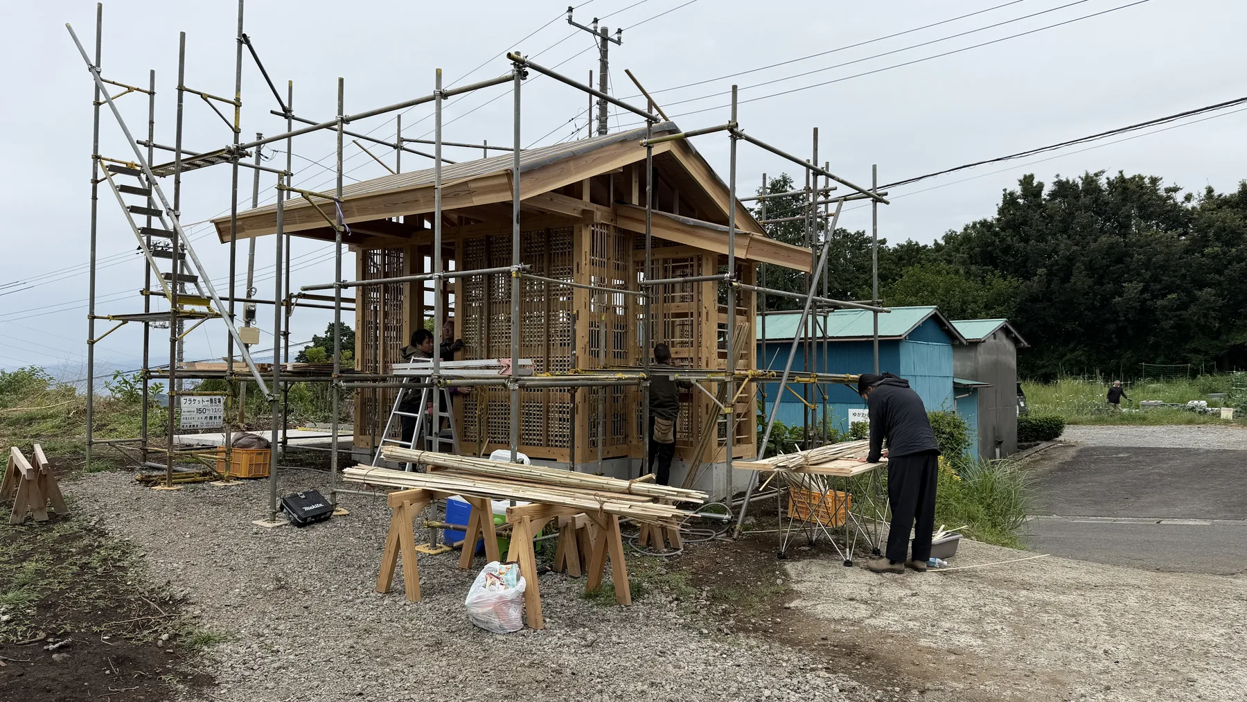 Rural Japanese wooden building under scaffolding as an example of akiya reuse, repair, and local infrastructure