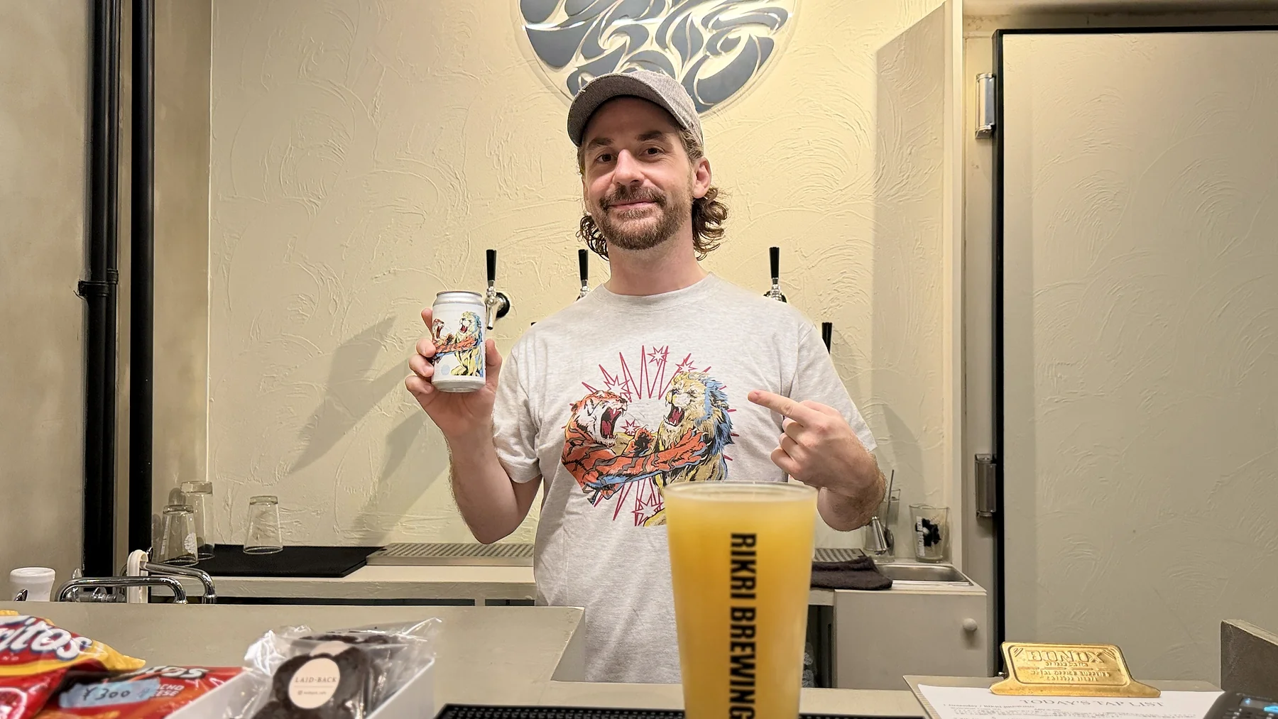 Matt Ketchum holding a can of Stellar Collision WIPA at Rikri Brewing